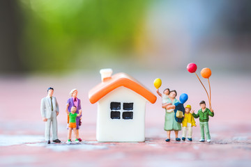 Many miniature with home. Concept of happy family and estate planning.