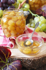 Green grapes confiture in jar and berries
