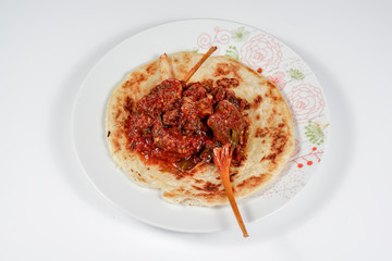 Spicy beef with chilli paste, served with a flat bread or Roti Canai