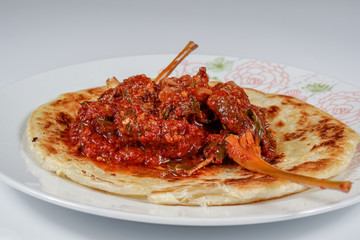 Spicy beef with chilli paste, served with a flat bread or Roti Canai