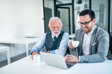Successful senior and junior businessman on a meeting.