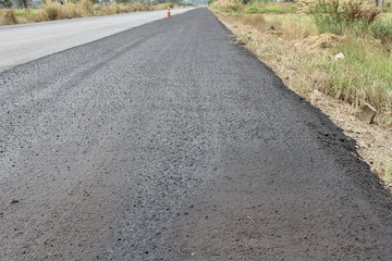asphalt road in field