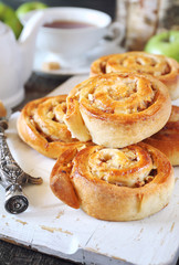 Sweet buns with apple and cinnamon and cup of tea