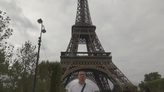 a tourist in front of Eiffel Tower, Paris, France