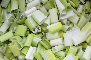 A bunch of clean, fresh and wet leek vegetables, already detached, cut and minced