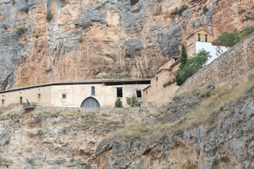 The Our Lady of Jaraba Sanctuary in the Barranco de la Hoz Seca canyon (Dry Defile Gully) in the Aragon region, Spain, during a sunny summer day