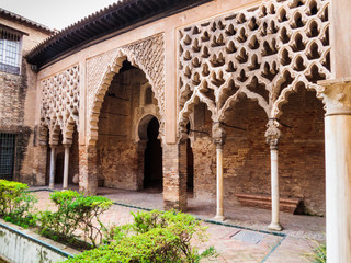 Alcázar courtyard with ornate arches Seville Spain