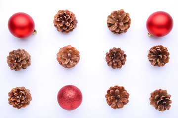 Christmas composition with pine cones and red christmas balls on white background