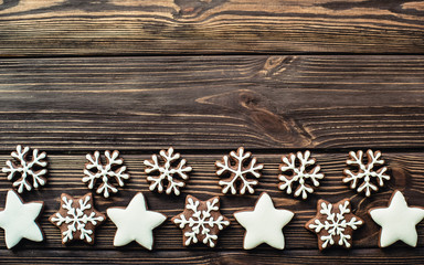 Gingerbread cookies snowflakes on wood table. copy space.