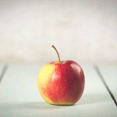 Apple on white wooden background