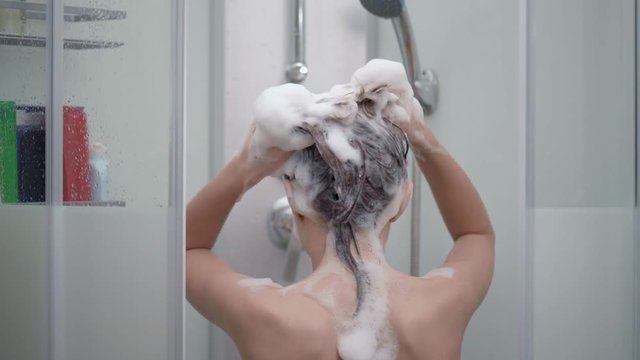 Teen girl bathing under shower