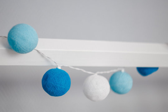 white and blue decoration balls, textile garland, cozy children's room concept