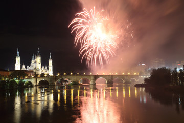 The fireworks during the 2018 Pilar festival next to the Pilar Cathedral and the Stone Bridge over the Ebro river, in Zaragoza, Aragon region, Spain