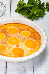 Peach Clafoutis in ceramic pie dish. Close up