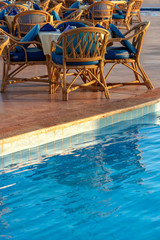 Fototapeta premium Poolside Set Dining Table with Wicker Chairs