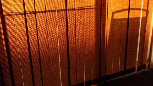 Timelapse of a chair through the blinds.
