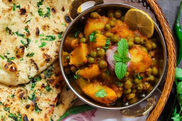 Homemade Kulcha / Indian flat bread Butter Naan served with Alu Matar