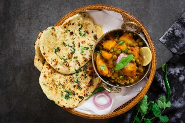 Homemade Kulcha / Indian flat bread Butter Naan served with Alu Matar
