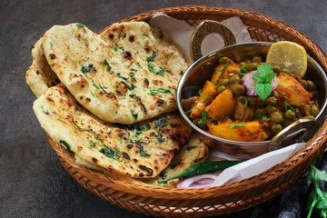 Homemade Kulcha / Indian flat bread Butter Naan served with Alu Matar
