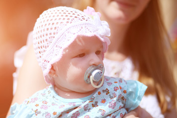 little baby with a pacifier in the mouth