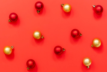 Christmas background. xmas red and gold balls on red background. Modern merry christmas card. Winter holiday theme. Happy New Year.