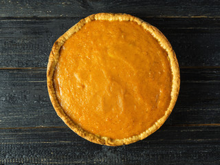 Close - up of orange pumpkin pie on the table