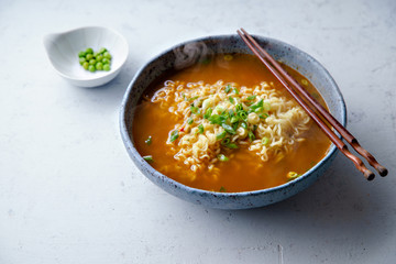 Easy japanese ramen with noodles, pork broth, egg and leek in handmade blue ceramic bowl with...