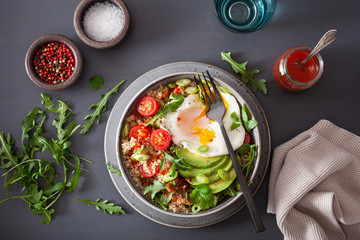 quinoa bowl with fried egg, avocado, tomato, rocket. Healthy vegetarian lunch