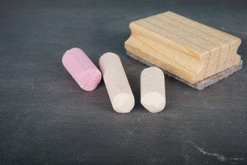 Coloured chalk over chalkboard. Selective focus