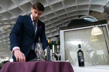 the young male sommelier while tasting red wine
