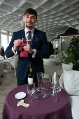 the young male sommelier while tasting red wine
