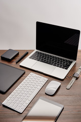 laptop with other various gadgets on graphics designer workplace