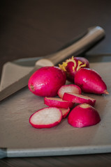 Pile of fresh ripe radishes on grey background