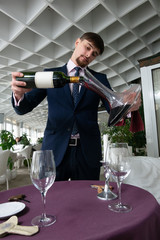 the young male sommelier while tasting red wine