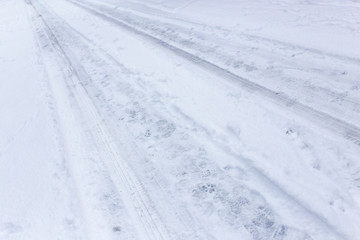 Traces of cars in the snow as a background