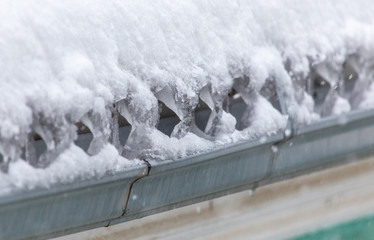 Snow on the roof of the house as a background