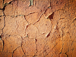 Old cracked wall with orange paint as background