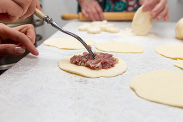 Cooking dough with meat on the table