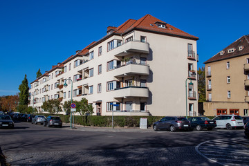 Beautiful street with wonderful reconstructed residential buildings from the 30s in front of blue sky