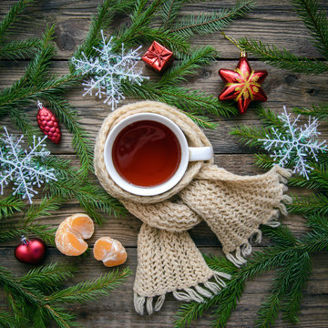 Christmas picture with a mug of tea in a scarf