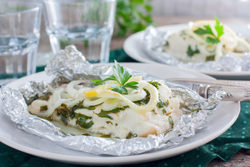 Cod baked in foil with parsley and onion, horizontal