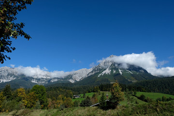 Kaiser mountains scene with clear blue sky and white clouds