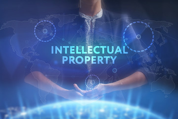 The concept of business, technology, the Internet and the network. A young entrepreneur working on a virtual screen of the future and sees the inscription: Intellectual property