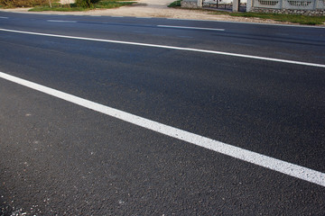Asphalt road with marking lines white stripes
