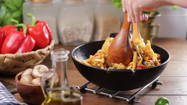 Indonesian pasta with chicken, pieces of bamboo and mushrooms.Seasoning, mixing, sprinkling and translating the dish.