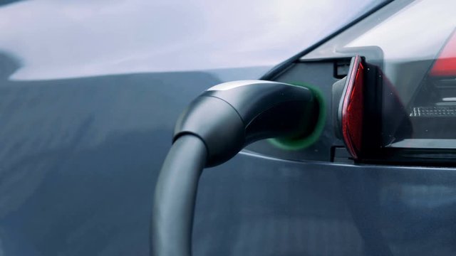 Electric plug in a car socket, close up.