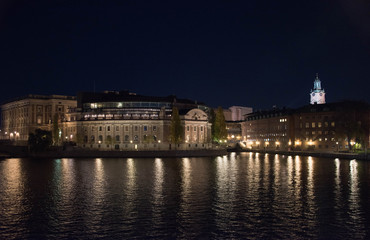 Fototapeta na wymiar Evening view in Stockholm shilouettes of old town, parliament houses , bridges and lake Mälaren