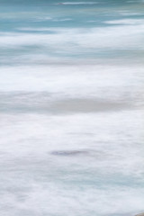 Long exposure of rocks and waves at Little Oberon bay in Wilsons Promontory national park, Victoria, Australia