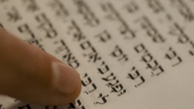 Macro Shot. Finger pointing hebrew text. Mishna, Pirkey Avot