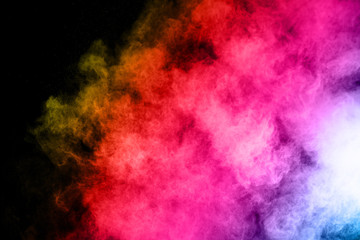 abstract colored dust explosion on a black background.abstract powder splatted background,Freeze motion of color powder exploding/throwing color powder, multicolored glitter texture.